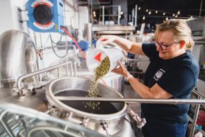 Pouring hops into a tank