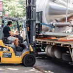 Unloading tanks off the truck with a forklift