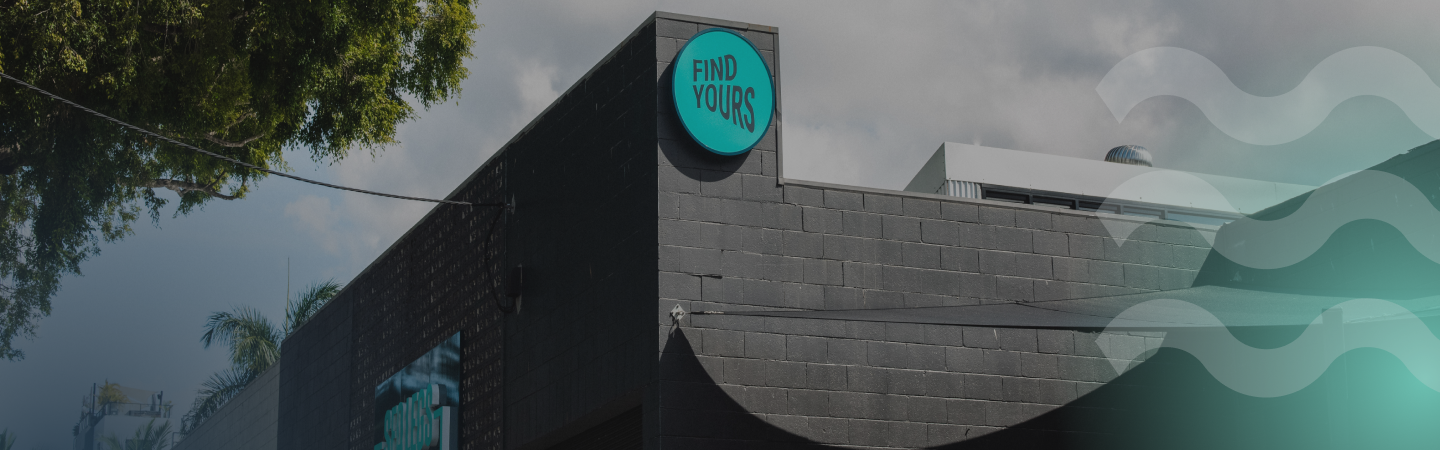 Wider shot of the "Find Yours" sign on the front facade of the building
