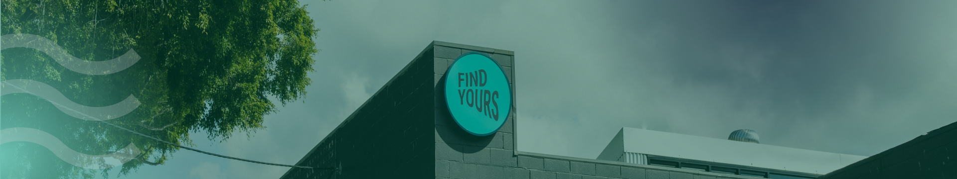 Closeup of the "Find Yours" sign on the front facade of the building